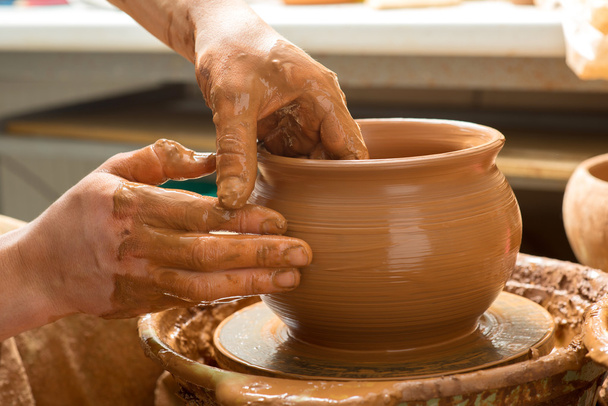 hands of a potter, creating an earthen jar - Valokuva, kuva