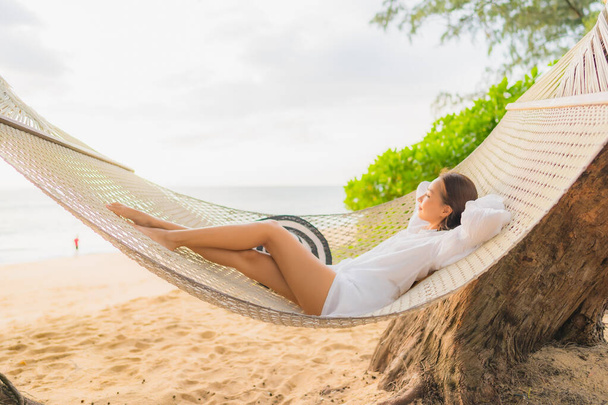 Portrait beautiful young asian woman relax on hammock around beach sea ocean for leisure in vacation - Foto, immagini