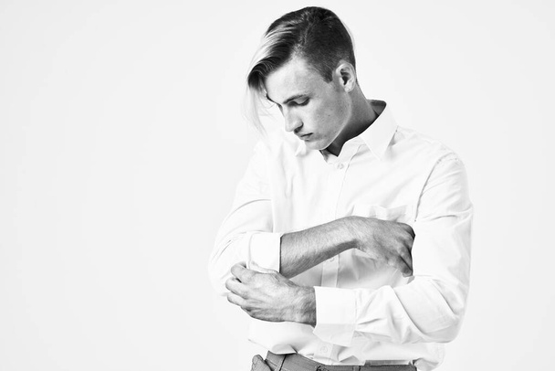 man guides the sleeve of white shirt model posing studio - 写真・画像