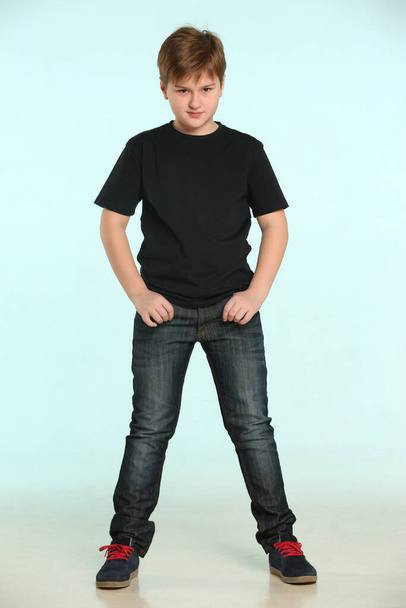 In the portrait smart and serious teenager standing in full length with his hands in his pockets. - Foto, Imagen