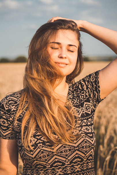 happy romantic young woman enjoying sunset nature on wheat field, girl breathe breathes deeply , freedom and relaxation concept - Foto, Imagen