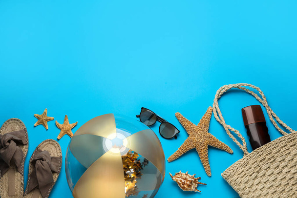 Flat lay composition with ball and beach objects on light blue background - Φωτογραφία, εικόνα