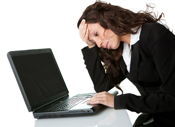 Stressful business woman working on laptop - 写真・画像
