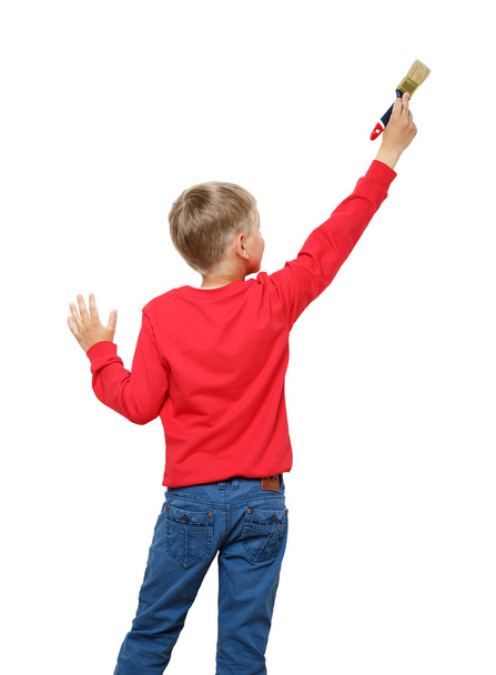 Little boy with paintbrush on wall, back view - Fotografie, Obrázek