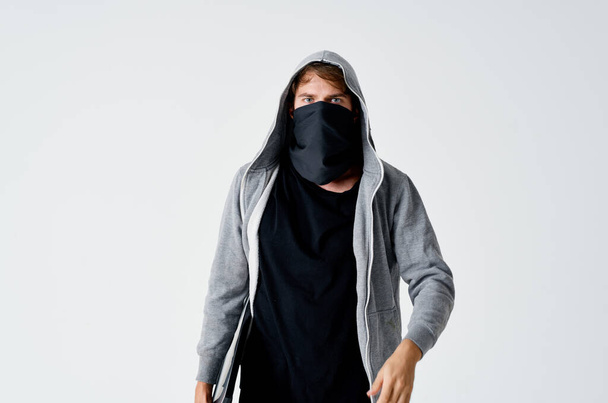thief in the hood covers the face of the crime theft of money anonymity - Fotoğraf, Görsel