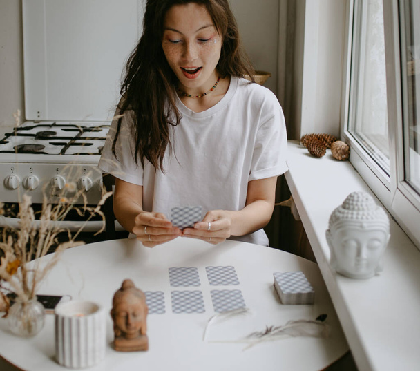mujer con cartas del tarot en la cocina blanca - Foto, Imagen