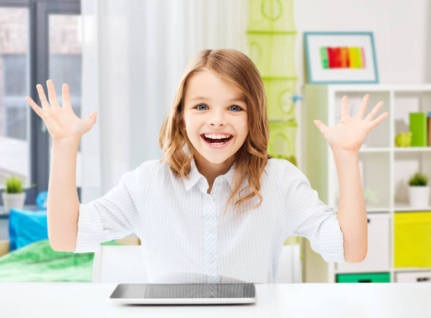 happy laughing student girl with tablet pc at home - Photo, Image