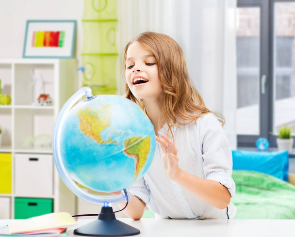 smiling student girl with globe at home - Zdjęcie, obraz