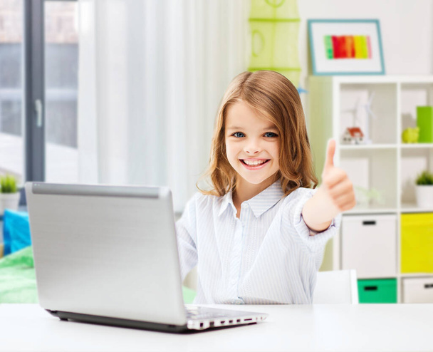 smiling student girl with laptop showing thumbs up - Photo, image