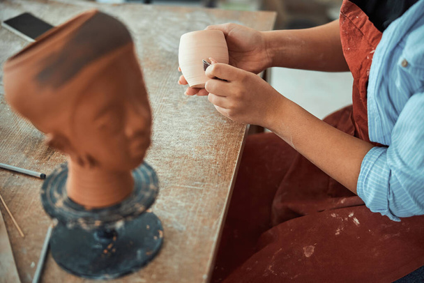 Female potter hands sanding ceramics in pottery workshop - Photo, Image