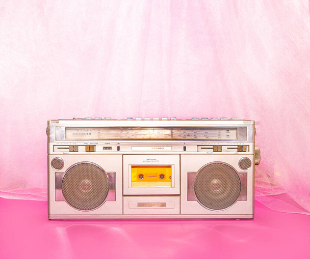 Retro music concept with silver cassette player against pink and purple background. - Valokuva, kuva