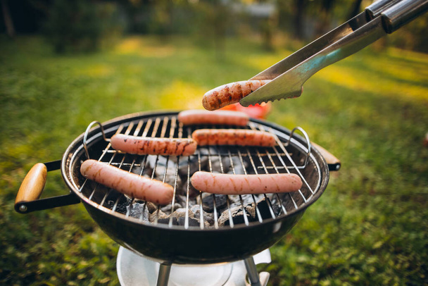 Close-up image of sausages on grill outside - Fotografie, Obrázek