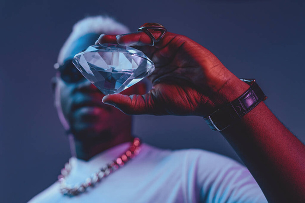 Rich african man with white hairs holding diamond - Photo, Image