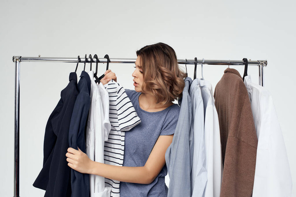 beautiful woman clothes hanger shopping studio emotion - Foto, Imagen