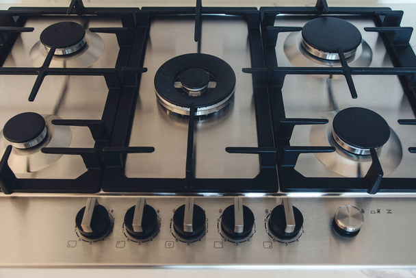 Kitchen gas stove, close up. New gas stove appliance and countertop surface at modern kitchen. Modern kitchen stove cook. - Photo, Image
