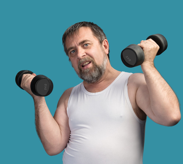 Az ember súlyzókkal gyakorol - Fotó, kép