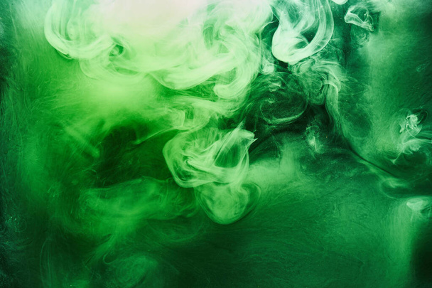 Abstract green color background. Swirling vibrant hookah smoke, underwater emerald ocean, dynamic paint in water - Foto, immagini