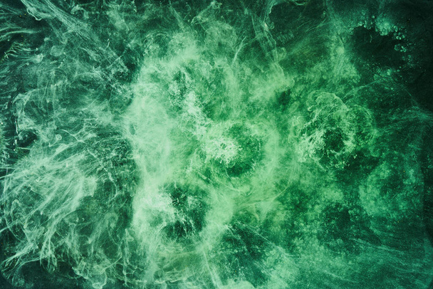 Abstract green color background. Swirling vibrant hookah smoke, underwater emerald ocean, dynamic paint in water - 写真・画像
