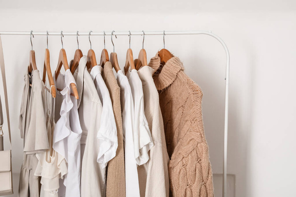 Rack with stylish clothes near light wall - Photo, Image