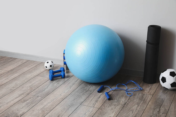 Set of sports equipment on floor in gym - Photo, Image
