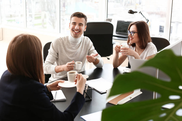 Business colleagues drinking coffee in office - Photo, image