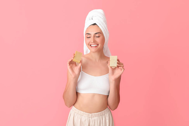 Beautiful young woman with soap on color background - Foto, afbeelding