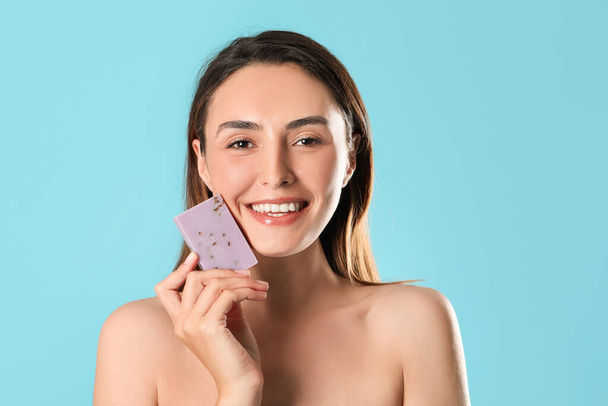 Beautiful young woman with soap on color background - Photo, Image