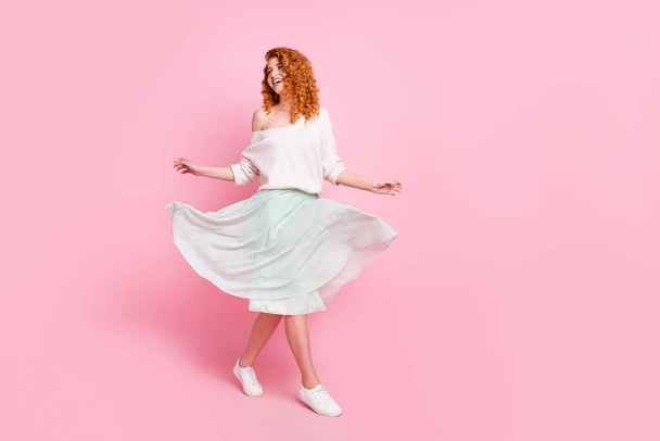 Full length body size photo of with red hair woman going forward looking copyspace smiling isolated on pastel pink color background - Фото, изображение