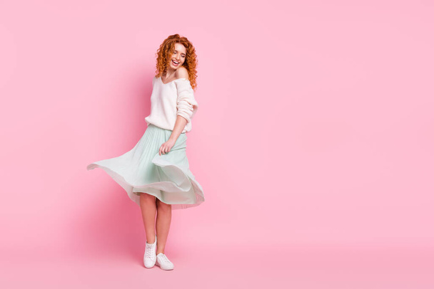 Full length body size photo of red hair woman smiling in skirt dancing spinning at party isolated on pastel pink color background - Foto, imagen