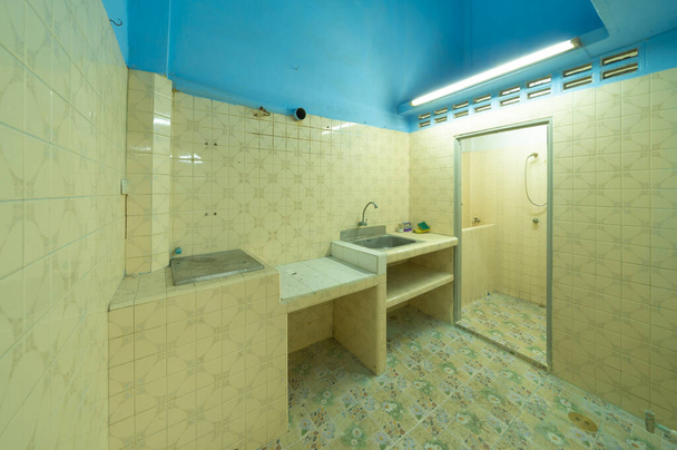 Empty dirty abandoned toilet and kitchen room in condominium or apartment with space. Interior. Old unfurnished room rental property, living space units. lifestyle. Ready for renovation. - Photo, Image