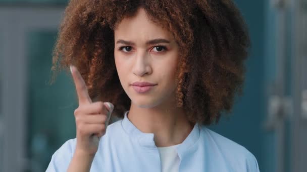 Female portrait outdoors young curly african american woman black mixed race smiling afro girl model student looking at camera waving finger negative scolding shaming prohibit gesture disapproval - Footage, Video