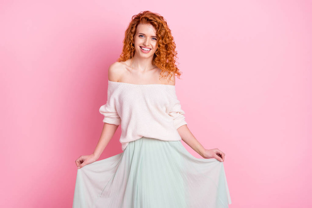 Photo portrait of young girl smiling happy keeping skirt wearing stylish clothes isolated pastel pink color background - 写真・画像