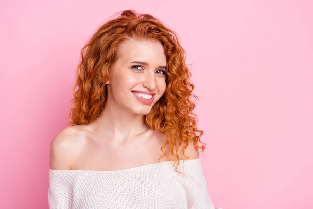 Photo portrait of red haired girl smiling cheerful in white sweater with off-shoulder isolated pastel pink color background - Fotografie, Obrázek