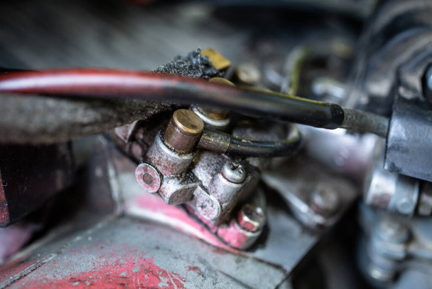 A close-up of a gasoline carburetor and a cable - Foto, Imagen