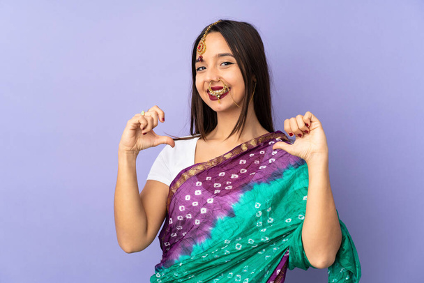 Young Indian woman isolated on purple background proud and self-satisfied - Foto, imagen