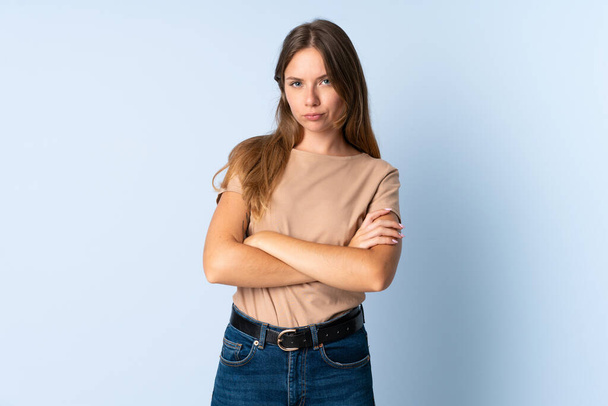 Young Lithuanian woman isolated on blue background feeling upset - Photo, Image