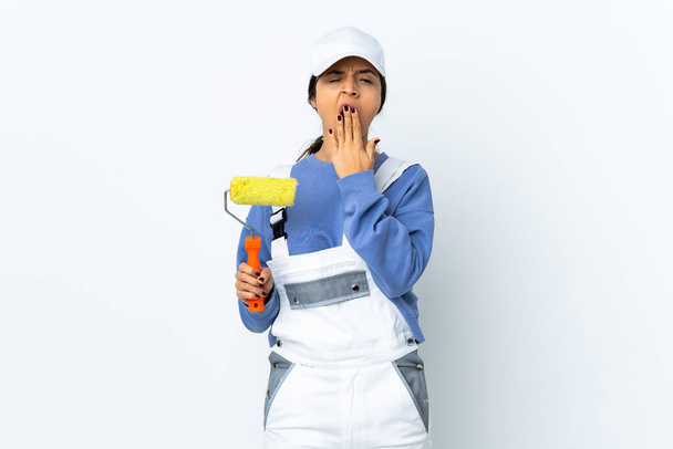 Painter woman over isolated white background yawning and covering wide open mouth with hand - Photo, Image