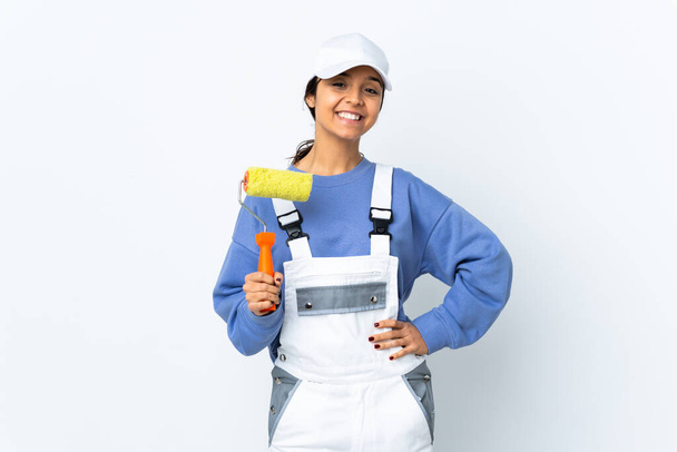 Painter woman over isolated white background posing with arms at hip and smiling - Photo, Image