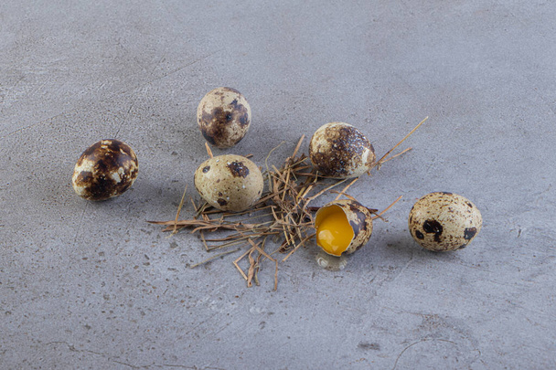 Raw fresh quail eggs placed on a stone background. High quality photo - Fotografie, Obrázek