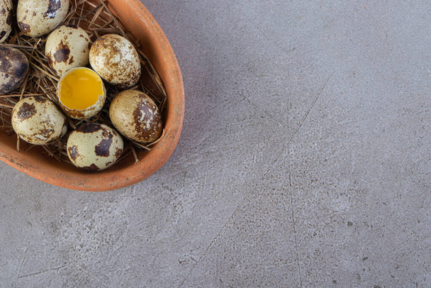 Raw fresh quail eggs placed on a stone background. High quality photo - Zdjęcie, obraz