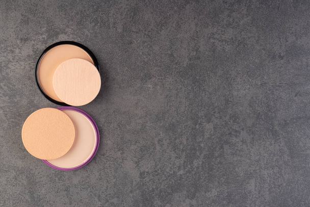 Natural powder foundation with sponges placed on stone surface  - Foto, Imagem