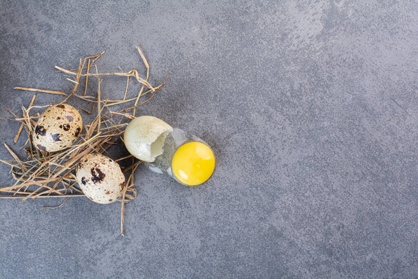 Fresh raw quail eggs placed on a stone table . High quality photo - Fotografie, Obrázek