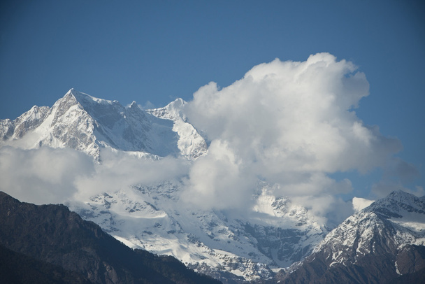 Clouds over the snowcapped mountains, Himalayas, Uttarakhand, In - Photo, Image