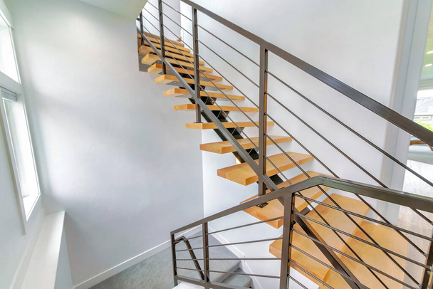 Modern staircase with metal and wood floating steps - 写真・画像