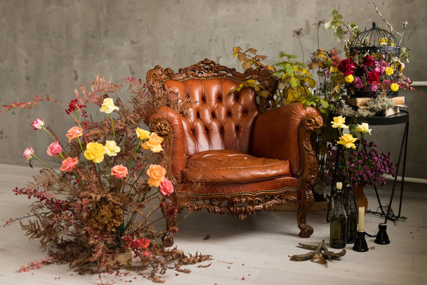 Fresh autumn arrangement with brown leather armchair - Photo, Image