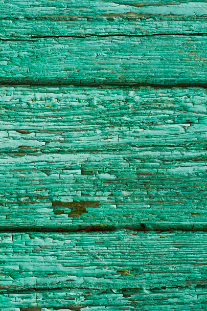The texture of the painted wooden boards. Background from old boards of green color. Paint peeled off from time to time - Fotografie, Obrázek