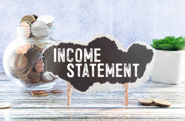 income statement, the text is printed on a piece of paper torn from a notebook on a craft background. - Valokuva, kuva