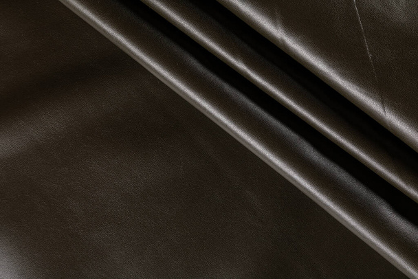 draped surface of imitation leather for sewing khaki color, background - Photo, image