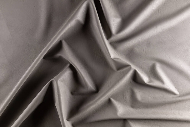 surface with folds of eco-leather for sewing light-gray clothes - Foto, Imagem
