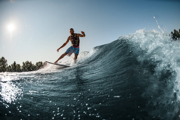 view of great splashing wave and man riding it on foilboard - Zdjęcie, obraz